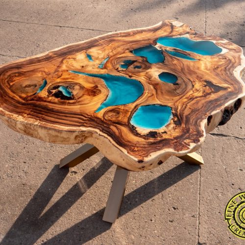 Round live edge dining table with glowing resin and golden legs, exotic suar wood