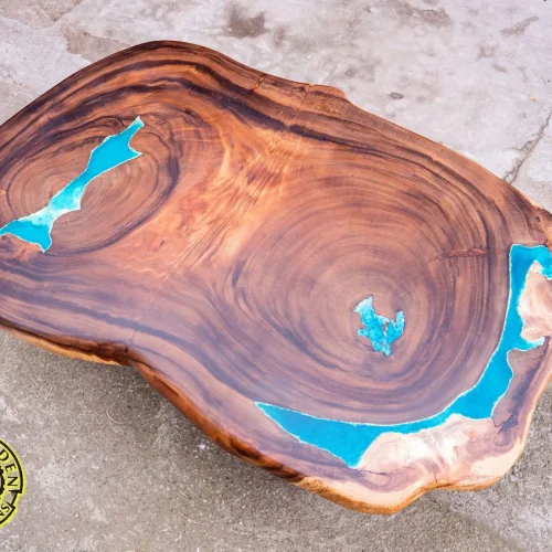 Coffee table made of exotic suar wood with glowing resin